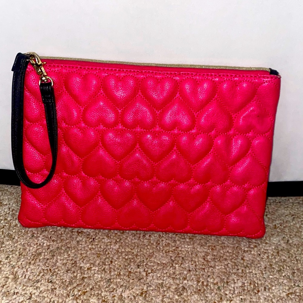 Betsy Johnson bright pink wristlet with sewn heart detail. Great condition.